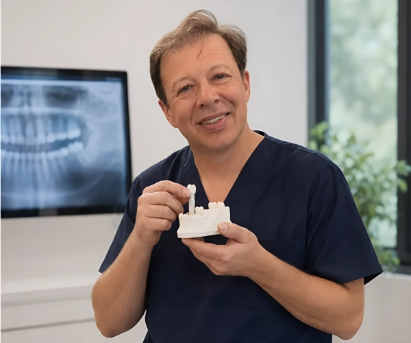 Dr. Boris Lipovetskiy explaining a ceramic dental implant model